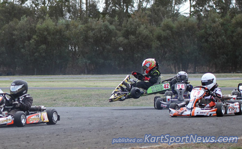 A first corner drama unfolds as karts scramble to avoid a stationary in turn 1 in Cadet 9. that's Annalise Ellis in the air.