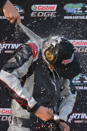 Jake Kostecki getting showered in champagne on the podium