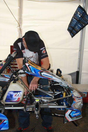 Who said guys can't mult-task? Pacific Kartsport's Dale Verrall does a front end alignment on Adam Mercer's Arrow whilst talking on the phone jammed between his ear and shoulder